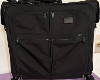 TUMI Alpha Extended Trip 4-Wheeled Rolling Garment Bag The gold standard of luxury travel. an absolute powerhouse for international business travelers. Built from proprietary, virtually indestructible FXT® ballistic nylon, the layout features smooth, multidirectional spinner wheels, integrated structural garment hangers to keep suits pristine, and a suite of water-resistant accessory pockets. This showroom-ready luggage allows serious travelers to secure elite performance without the retail wait.