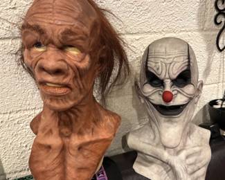 “The Hillbilly" & "Killer Clown" Fine-Art Silicone Display Busts Museum-grade character design. This breathtaking collection features two full-size collector busts sculpted with exceptional anatomical precision. "The Hillbilly" showcases incredibly realistic skin folding, age spotting, and individually rooted hair clusters. "The Killer Clown" delivers an elite, stylized design featuring monochromatic skin styling and an exaggerated chin profile. Displayed on professional pedestals, these are true anchor pieces for an elite horror art collection.