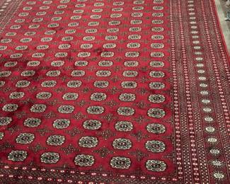 Vintage Red Bukhara (Tehke) Hand-Knotted Wool Rug Traditional symmetry and rich heritage. showcases the iconic repeating geometric medallion design in a captivating palette of deep crimson, stark cream, and midnight black. Woven with high-density premium wool pile, it offers incredible durability and a classic, scholarly aesthetic that grounds home libraries, executive studies, or formal dining rooms perfectly.