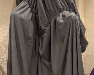 The "Weeping Weeper" Animated Motion & Vocal Phantom towering, completely hidden faceless figure wrapped in a heavy charcoal shroud. A masterpiece of high-tension theatrical automation. While its towering silhouette wrapped in cascading charcoal fabric delivers an atmosphere of deep gothic dread, this premium asset features fully integrated power mechanics. When connected to a power supply, the phantom comes alive with precise, synchronized motor-driven head and torso movements, paired with a chilling, high-fidelity vocal track broadcast system. Outfitted with specialized sensor triggers for seamless, hands-free automation, this commercial-grade scare asset is built to anchor a premium entryway or high-end haunted attraction layout.