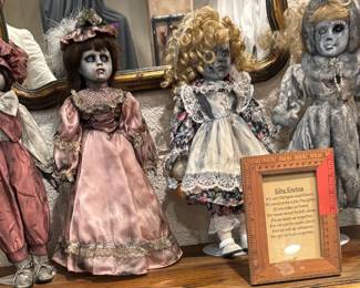 The "Morgan & Harry" Gothic Art Twin Doll Collection + Framed Poem A masterclass in dark whimsey. features four meticulously altered collector dolls dressed in weathered Victorian silk and lace garments. Their porcelain-styled faces are hand-detailed with exquisite trauma fractures, glass-inset gazes, and haunt-style distressing. The collection is anchored by a custom-framed narrative plaque detailing the lore of the twins, "Morgan and Harry," elevating this from simple decor to a museum-worthy conversational display for an elite horror or oddities gallery