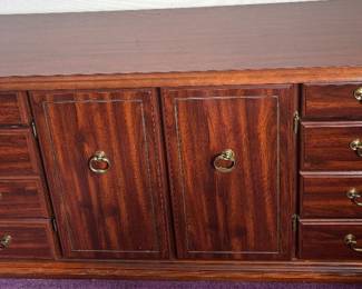 Fantastic Deal  Traditional Mahogany Finish 8-Drawer Credenza  Multi-functional media console or buffet sideboard featuring rich flame-grain wood veneers. Centered dual cabinet doors open to vast storage, flanked by classic brass swing bail pulls. Grounded block base provides an elegant, authoritative silhouette.