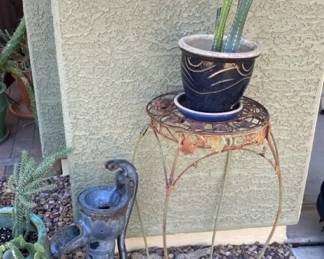 An Old Cast Iron Hand Water Pump and Two Cactus Plants