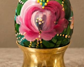 Hand-Painted Floral Egg — Decorative green egg featuring pink flowers, colorful accents, and brass display stand.