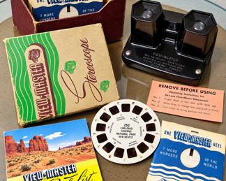 Vintage View-Master Stereoscope Collection ◆ Black stereoscopic viewer ◆ Original View-Master box ◆ Storage box with assorted reels ◆ Carlsbad Caverns National Park reel ◆ Vintage reel sleeves ◆ Illustrated reel catalog ◆ Original operating instructions ◆ Mid-century collectible set