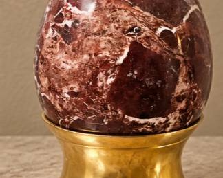 Maroon Stone Egg — Polished deep burgundy stone with natural white veining and brass display stand.