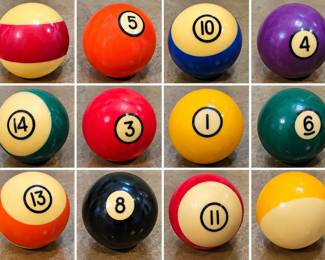 Assorted Billiard Pool Balls — Colorful numbered solid and striped pool balls with glossy finishes. Various colors and numbers; assorted lot.