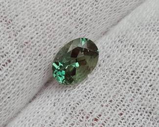 0.76 Carat Greenish-Blue Faceted Oval Gemstone