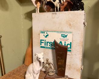 Collection of pulleys, cypress knee, vintage metal first aid, cow figurines