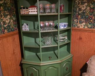 vintage green corner china cabinet / hutch featuring an arched top, open display shelves