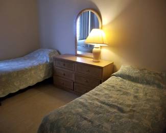 Twin beds; dresser with mirror