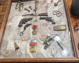 Shadow box of minatures, medals, toy pistols, keys brass soes, pipe