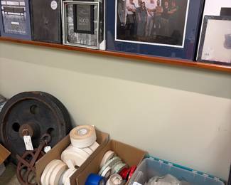 Nicely framed and matted artwork, foam tapes, and felt padding, wooden industrial pulley, metal industrial pulley, and assorted tapes.