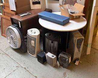 Electric heaters, fan, drop leaf table, cocktail table, and custom desk lighting.