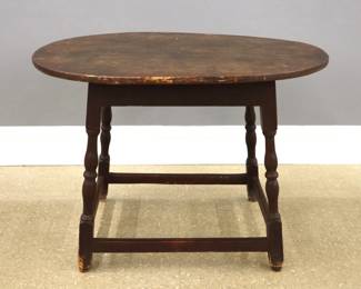 An 18th century New England Windsor tavern table.   Maple construction features an oval two-board top on a base with splayed turned legs and lower stretcher.  Painted collection inventory number at underside.  Old finish with wear, top with some shrinkage and filler, minor damage to two feet.  34 3/4 x 27 x 25" high overall.