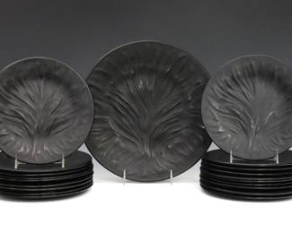 Twenty Lalique "Algues Noir" pattern Black Crystal plates.  Molded Black glass plates with "Tree of Life" pattern at the well.  Each signed "Lalique France", some with "Made in France" labels.  Light wear, some surface scratches.  Nineteen plates at 7 3/4" diameter, one at 11 1/4" diameter.  