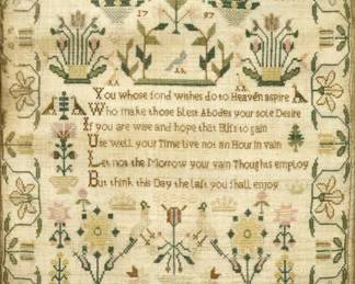 An 18th century English Needlework Sampler.  Made by "Elizabeth Watson 1797" with styled floral motif in Yellow, Blue, Brown, and Green that contains a religious rhyme and stylized images of plants, flowers, birds, and crowns.   Some staining and wear overall.  Image 14 3/8 x 17 1/2" h, in a later wood frame with some wear, 16 1/2 x 19 1/4" high overall.  