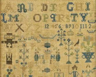 A 19th century English Needlework Sampler.  Features four rows of alphabet and numbers with stylized motifs of crowns, flowers, people, animals, Christ crucified, and the year "1812"; all in muted tones of Blue, Green, Brown, and Yellow.  Fading and some staining and losses.  Image 11 5/8 x 11 5/8" high, in a simple wood frame with wear, 13 1/4 x 13 1/4" high overall.  