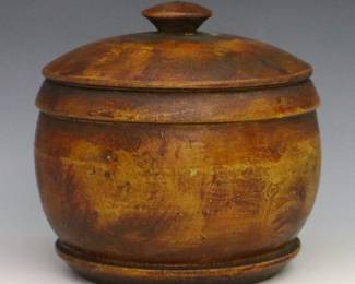 A 19th century American treenware covered box.  Softwood construction with circular form and vinegar grain-painted decoration.  Some wear and shrinkage.  5 x 4 1/2" high overall.  