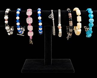 Elegant Gemstone Bracelets on Velvet Stand