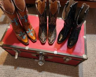 Western boots and red footlocker