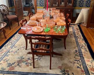 Table full of pink Miss America glassware