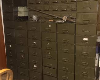 lots of stacking metal files and a 15 drawer file
