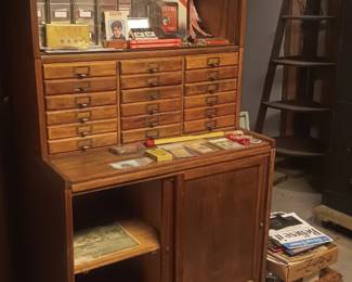 3 stack cabinet with drawers in the middle and glass door unit on top