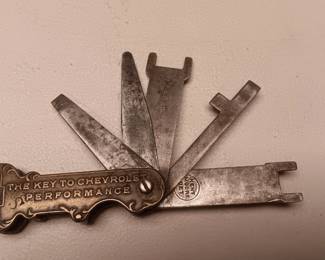 antique Chevrolet multi tool shaped like a key