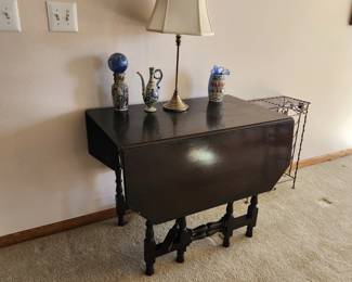 Antique Drop leaf/gate leg table in dark wood. One leg has issues. Beautiful carved legs with cut corners to make an octagon. Dimensions :     Asking $180. Will entertain offers