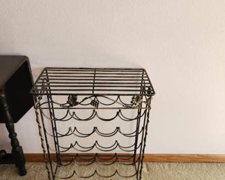 Powder coated metal wine rack. holds aprox 20 bottles of wine. Great for plants as well as wine.  Dimensions : 20 w x 10 d x 27 h. Asking $20. Will entertain offers