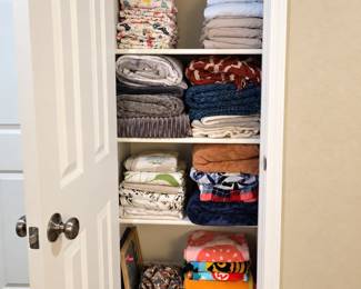 Linen closet with beach towels, shower curtains, sheet sets, throw blankets and more...