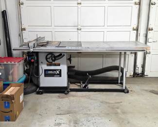 Delta Unisaw cabinet table saw with extension table and rip fence.