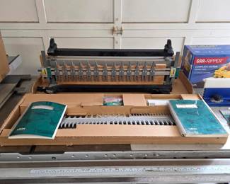 Leigh dovetail jig with adjustable fingers, templates and instruction manuals.