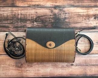 Wooden handbag with curved body, contrasting flap and decorative cutwork sides.