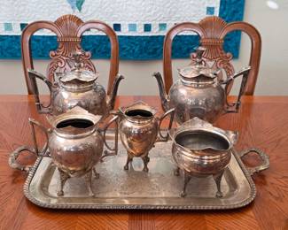 Vintage Meriden Britannia Company Victorian ornate silver-plated tea and coffee service with floral engravings, featuring two pots, creamers, a sugar bowl (circa 1884)