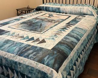 Eagle-themed bed quilt with a scenic wildlife center, multiple blue-gray borders, and extensive triangle piecing. The full display reveals the scale and balance of the design.