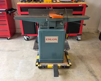 Enlon woodworking jointer with fence and mobile base.