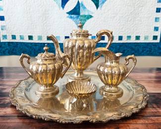 Sterling silver coffee/tea service with tray, creamer, covered sugar and shell bowl; acquired in Taxco, Mexico, in the late 1940s according to the family letter.