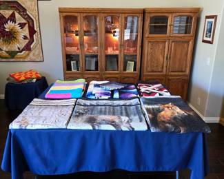 Meet the Cuddle Table: handmade quilts by Cathy Farris, including wildlife designs and colorful patchwork, with soft Minky-backed selections made for wrapping up in comfort.