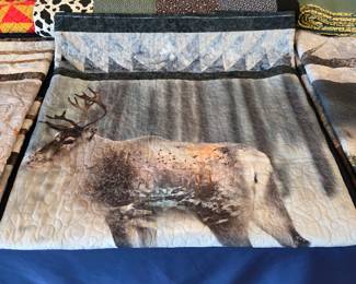 Handmade elk wildlife quilt with woodland imagery and decorative quilting.
