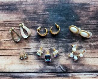 Stud, hoop, and drop earrings, plus a coordinating pendant-and-earring set with rainbow-colored stones. Small accessories with plenty of sparkle.