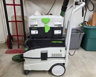 Festool CT 26 E dust extractor with hose and stacked tool storage.