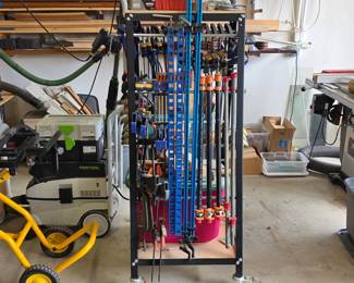 Woodworking clamp collection with bar clamps and mobile clamp storage rack.