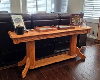 Traditional oak sofa console table with trestle base, featuring a lower shelf