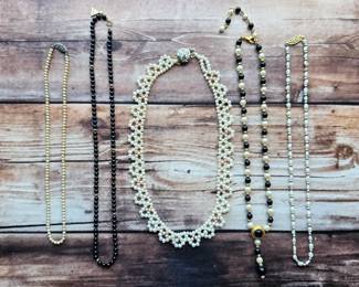 Pearl-style strands, multistrand beaded necklaces, and black-and-white designs. Explore classic and statement looks in this varied jewelry collection.