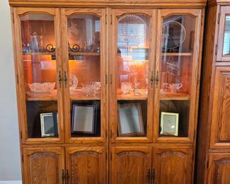Large vintage light oak display cabinets with glass-front upper doors, interior lighting, lower storage cabinets