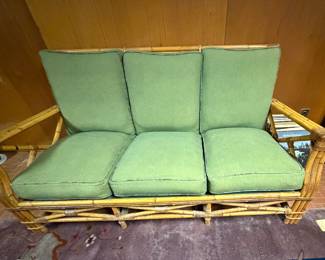 Set of Ficks Reed style bamboo furniture: 3-cushion sofa, two arm chairs and glass topped coffee table