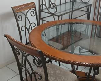 Gorgeous round glass top dining table with four chairs and matching Baker's rack. Glass top has never been uncovered. Like new.
