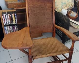 Unique antique chair has fold down writing table or armrest.